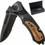 Personalized pocket knife with custom engraved wooden handle overlay and black tactical serrated blade in its gift box