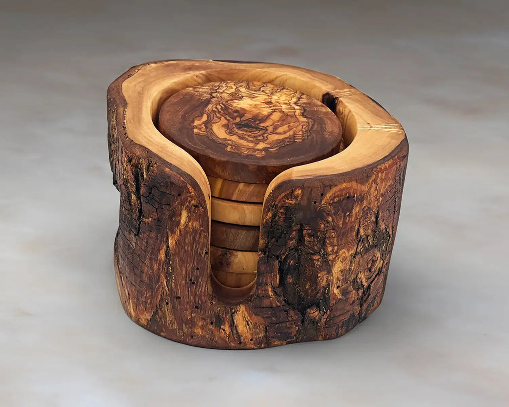 Set of wooden drink coasters made from live edge olive wood with a rustic holder. Features a vintage design with unique natural grain patterns, perfect for protecting surfaces and adding charm to table decor