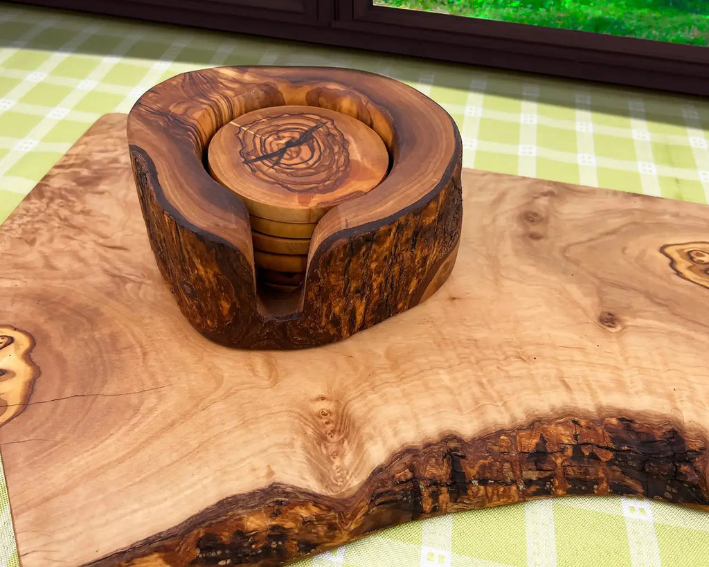 Set of wooden drink coasters made from live edge olive wood with a rustic holder. Features a vintage design with unique natural grain patterns, perfect for protecting surfaces and adding charm to table decor